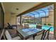 Covered patio with pool, spa, and dining furniture at 1603 Lima Ave, Kissimmee, FL 34747
