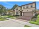 Two-story house with two-car garage and manicured lawn at 1603 Lima Ave, Kissimmee, FL 34747