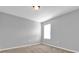 Bright bedroom with neutral walls, carpet flooring, and a window with blinds at 1961 Nations Way, St Cloud, FL 34769