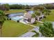 Community clubhouse and pool next to a pond at 22103 Sandalwood Dr # 103, Wildwood, FL 34785