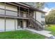 Two story building with brown wooden stairs and balconies at 22103 Sandalwood Dr # 103, Wildwood, FL 34785