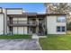 Tan two-story building with multiple units, balconies, and stairs at 22103 Sandalwood Dr # 103, Wildwood, FL 34785