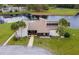 Community pool and clubhouse with lush landscaping at 22103 Sandalwood Dr # 103, Wildwood, FL 34785