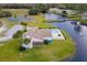 Aerial view of community clubhouse near tennis courts and pond at 22103 Sandalwood Dr # 103, Wildwood, FL 34785
