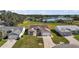 Aerial view of three homes near a lake and golf course at 25114 Meriweather Rd, Leesburg, FL 34748