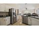 Kitchen boasts stainless steel appliances and an island with seating at 25114 Meriweather Rd, Leesburg, FL 34748
