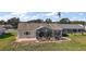Backyard features a screened patio and grassy area at 25114 Meriweather Rd, Leesburg, FL 34748