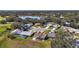 Community view showcasing houses, lake, and lush greenery at 25114 Meriweather Rd, Leesburg, FL 34748