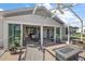 Spacious screened patio with seating and fire pit at 25114 Meriweather Rd, Leesburg, FL 34748