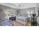 Well-lit bedroom with twin and full-size beds and an exercise machine at 25114 Meriweather Rd, Leesburg, FL 34748