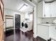 Bright laundry room with modern washer and dryer, and stylish white cabinets at 33413 Fairway Rd, Leesburg, FL 34788