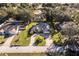 Aerial view of a single-Gathering home with a large yard and circular driveway at 33516 Overton Dr, Leesburg, FL 34788