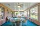 Relaxing sunroom featuring wicker furniture and a glass table at 33516 Overton Dr, Leesburg, FL 34788