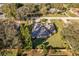 Aerial view of a single-Gathering home showcasing its backyard and landscaping at 33516 Overton Dr, Leesburg, FL 34788