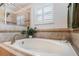 Soaking tub with window and built in shelving at 34045 Alameda Dr, Sorrento, FL 32776