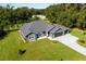 Single-story gray house with a two-car garage and large yard at 3927 Oak Pointe Dr, Lady Lake, FL 32159