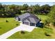 Single-story gray house with a two-car garage and large yard at 3927 Oak Pointe Dr, Lady Lake, FL 32159