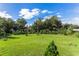 Spacious backyard with lush green grass and mature trees at 3927 Oak Pointe Dr, Lady Lake, FL 32159