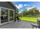 Spacious backyard with patio, lawn, and flag at 3927 Oak Pointe Dr, Lady Lake, FL 32159