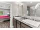 Double vanity bathroom with marble countertop and a view of the bedroom at 3927 Oak Pointe Dr, Lady Lake, FL 32159
