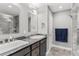 Elegant bathroom with double vanity and a large walk-in shower at 3927 Oak Pointe Dr, Lady Lake, FL 32159