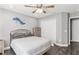 Bright bedroom with a queen-size bed, double doors, and wood-look floors at 3927 Oak Pointe Dr, Lady Lake, FL 32159