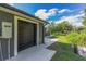 Single-car garage with dark gray door and concrete path at 3927 Oak Pointe Dr, Lady Lake, FL 32159