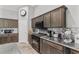 Modern kitchen with dark wood cabinets and granite countertops at 3927 Oak Pointe Dr, Lady Lake, FL 32159