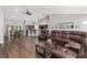 Open living space with hardwood floors, leather furniture, and kitchen views at 3927 Oak Pointe Dr, Lady Lake, FL 32159