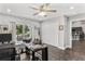 Home office features a glass desk, wood floors, and a view of the kitchen at 3927 Oak Pointe Dr, Lady Lake, FL 32159