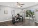 Home office with glass desk, wood floors, and backyard access at 3927 Oak Pointe Dr, Lady Lake, FL 32159