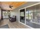 Covered porch with wooden ceiling, seating, and sliding glass doors at 3927 Oak Pointe Dr, Lady Lake, FL 32159