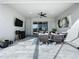 Outdoor patio includes a TV, seating area, and sliding glass doors at 405 Amola Way, Howey In The Hills, FL 34737