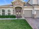 Inviting house entrance with double doors, stonework, and landscaping at 405 Amola Way, Howey In The Hills, FL 34737
