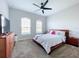 Spacious Primary bedroom featuring a large bed, and plenty of natural light at 405 Amola Way, Howey In The Hills, FL 34737
