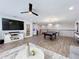 Open game room with pool table, large TV, and wet bar at 405 Amola Way, Howey In The Hills, FL 34737
