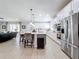Open kitchen with stainless steel appliances and large island at 405 Amola Way, Howey In The Hills, FL 34737