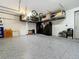 Garage with overhead storage and epoxy flooring at 405 Amola Way, Howey In The Hills, FL 34737