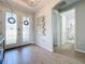 Light-filled entry hall with access to a bathroom and double doors at 405 Amola Way, Howey In The Hills, FL 34737