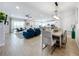 Open concept dining area with a large table and modern light fixture at 405 Amola Way, Howey In The Hills, FL 34737