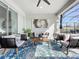 Relaxing covered patio with wicker furniture and a blue patterned rug at 405 Amola Way, Howey In The Hills, FL 34737