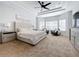 Primary bedroom with a large bed, sitting area, and natural light at 405 Amola Way, Howey In The Hills, FL 34737