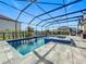 Inviting pool and spa with a screened enclosure and spacious patio at 405 Amola Way, Howey In The Hills, FL 34737