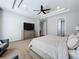 Primary bedroom with a comfy bed, dresser, and a view of another room at 405 Amola Way, Howey In The Hills, FL 34737