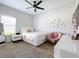 Well-lit bedroom with a queen bed, a comfortable chair, and a vanity at 405 Amola Way, Howey In The Hills, FL 34737