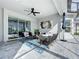 Covered patio features wicker furniture, a ceiling fan, and sliding glass doors at 405 Amola Way, Howey In The Hills, FL 34737