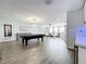 Game room with pool table, seating area, and wet bar at 405 Amola Way, Howey In The Hills, FL 34737