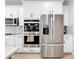 Modern kitchen with stainless steel appliances and white cabinetry at 405 Amola Way, Howey In The Hills, FL 34737