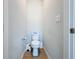 Small powder room with toilet and pedestal sink at 405 Amola Way, Howey In The Hills, FL 34737