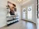 Spacious entryway featuring a console table, artwork, and double doors at 405 Amola Way, Howey In The Hills, FL 34737
